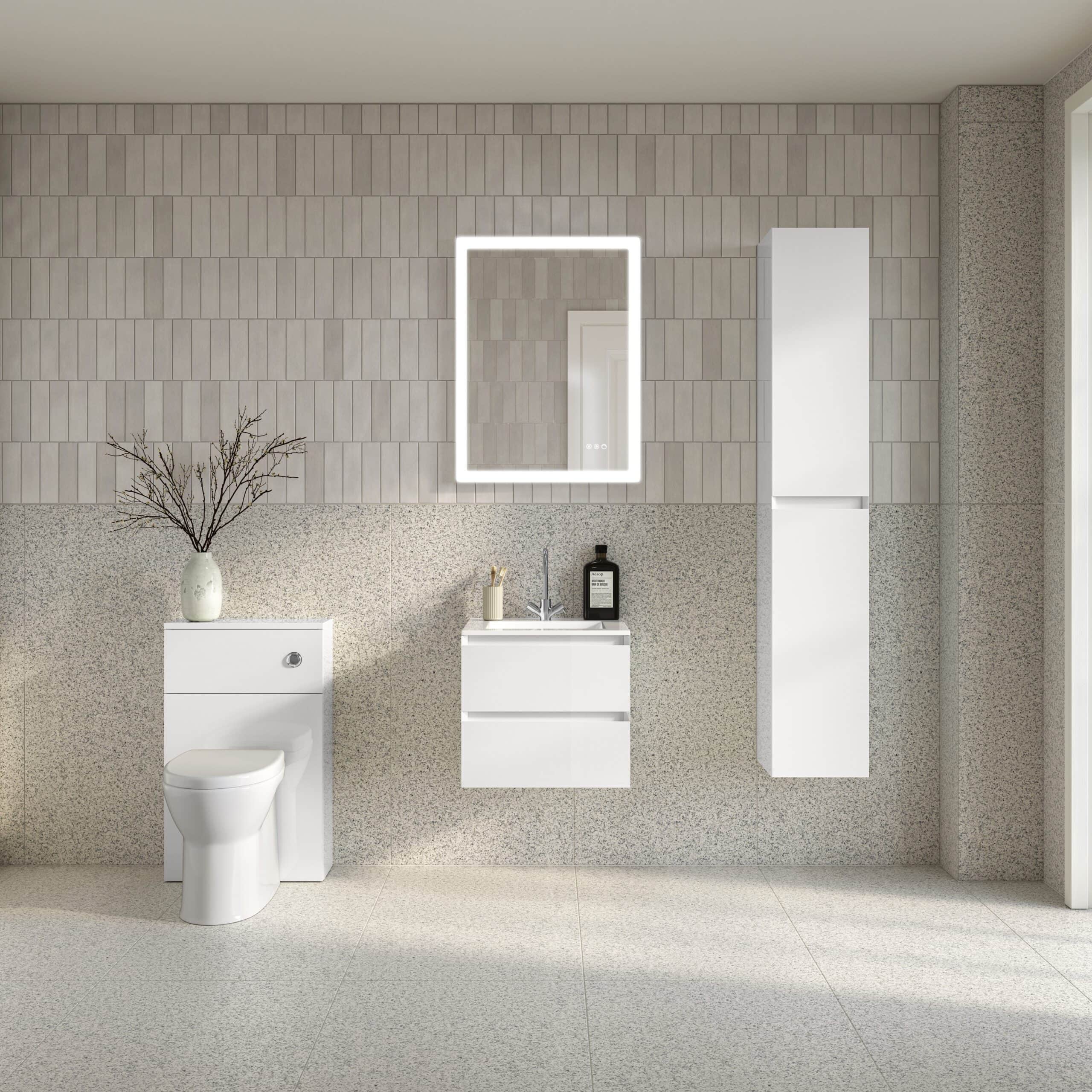 Sleek modern bathroom with white toilet, vanity unit, mirrored LED light, and tall storage cabinet, featuring minimalist design and neutral tones.