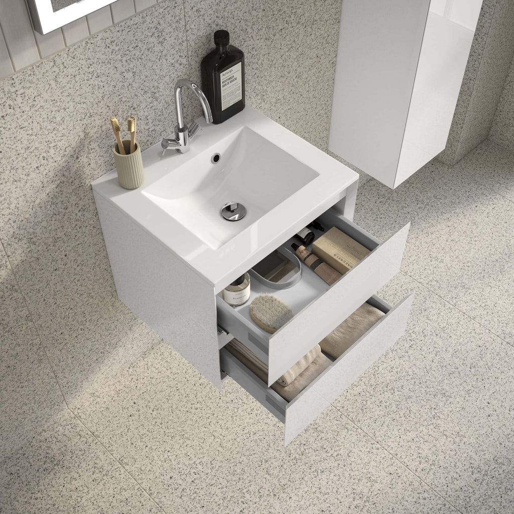 Sleek white bathroom vanity with open drawers featuring bathroom accessories and toiletries, ideal for modern bathroom storage solutions, enhanced by Bubly Bathrooms.