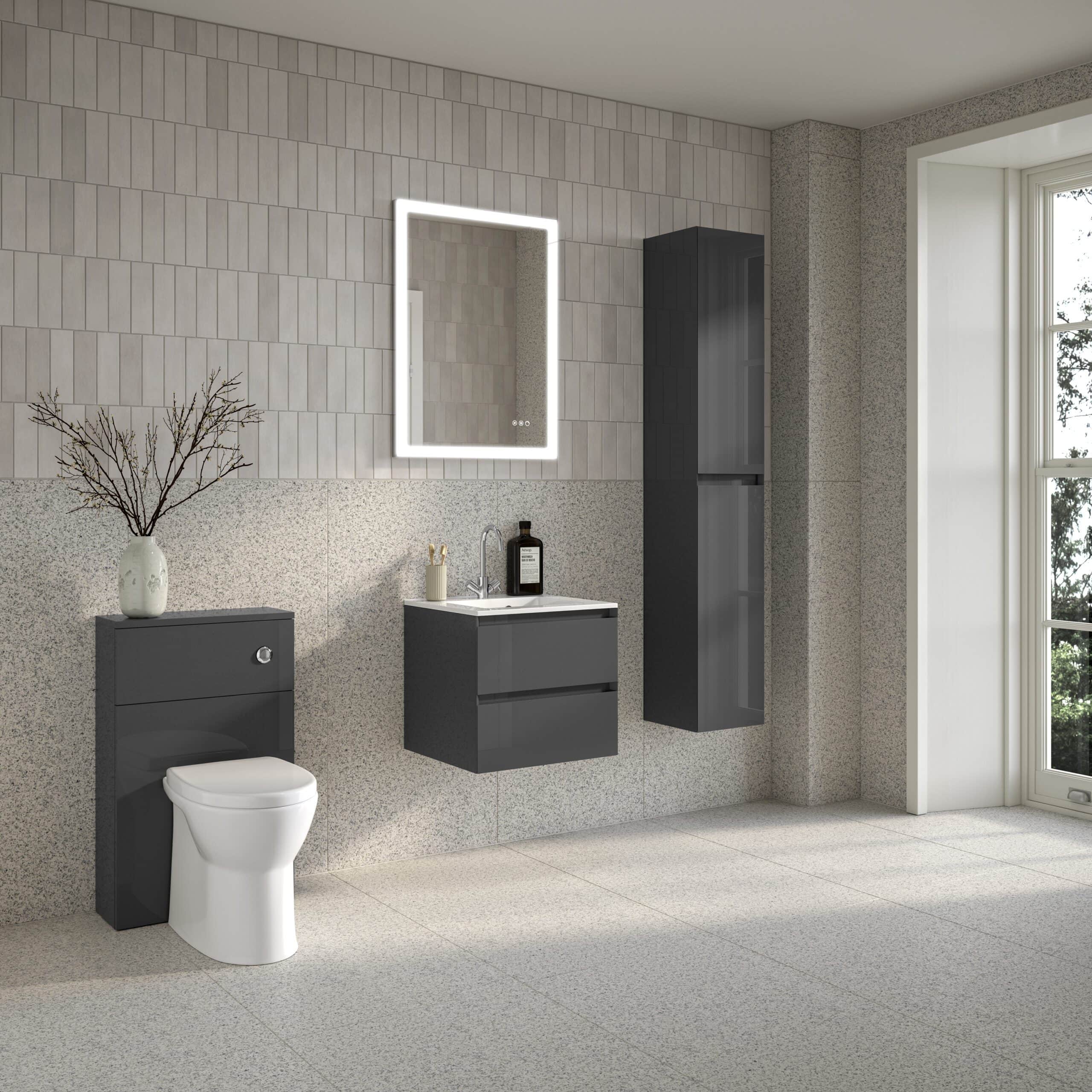 Sleek modern bathroom with wall-mounted toilet, grey vanity unit, tall black storage cabinet, illuminated mirror, and minimalist decor, showcasing contemporary bathroom design.