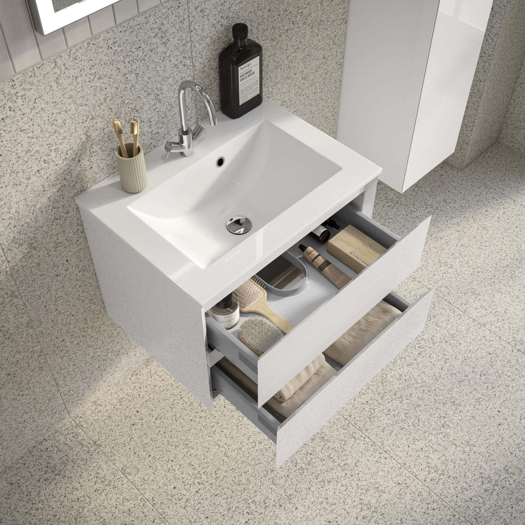 Sleek modern white bathroom vanity with open drawers revealing storage for toiletries and towels, ideal for contemporary bathroom organisation and design.
