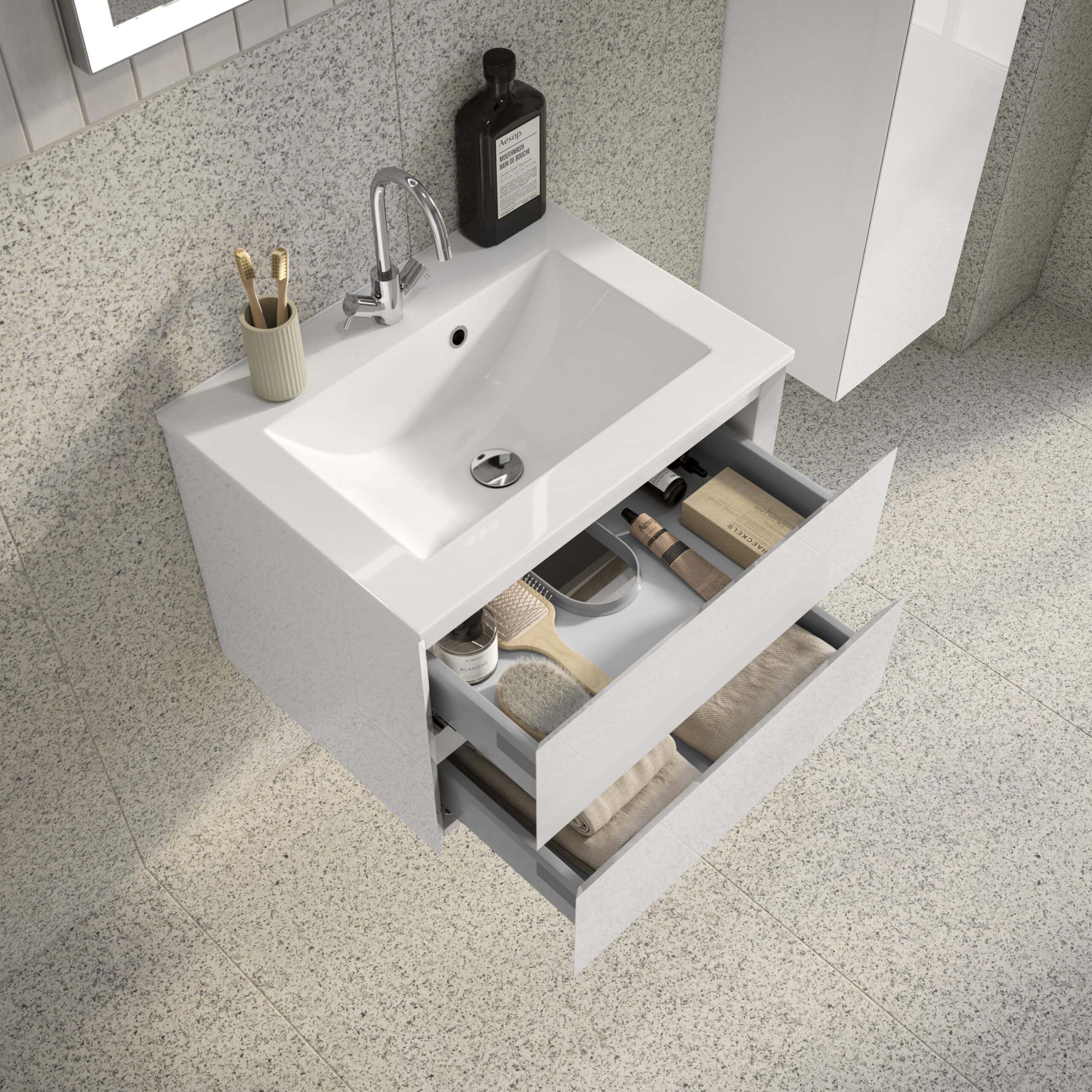Sleek modern white bathroom vanity with open drawers revealing storage for toiletries and towels, ideal for contemporary bathroom organisation and design.