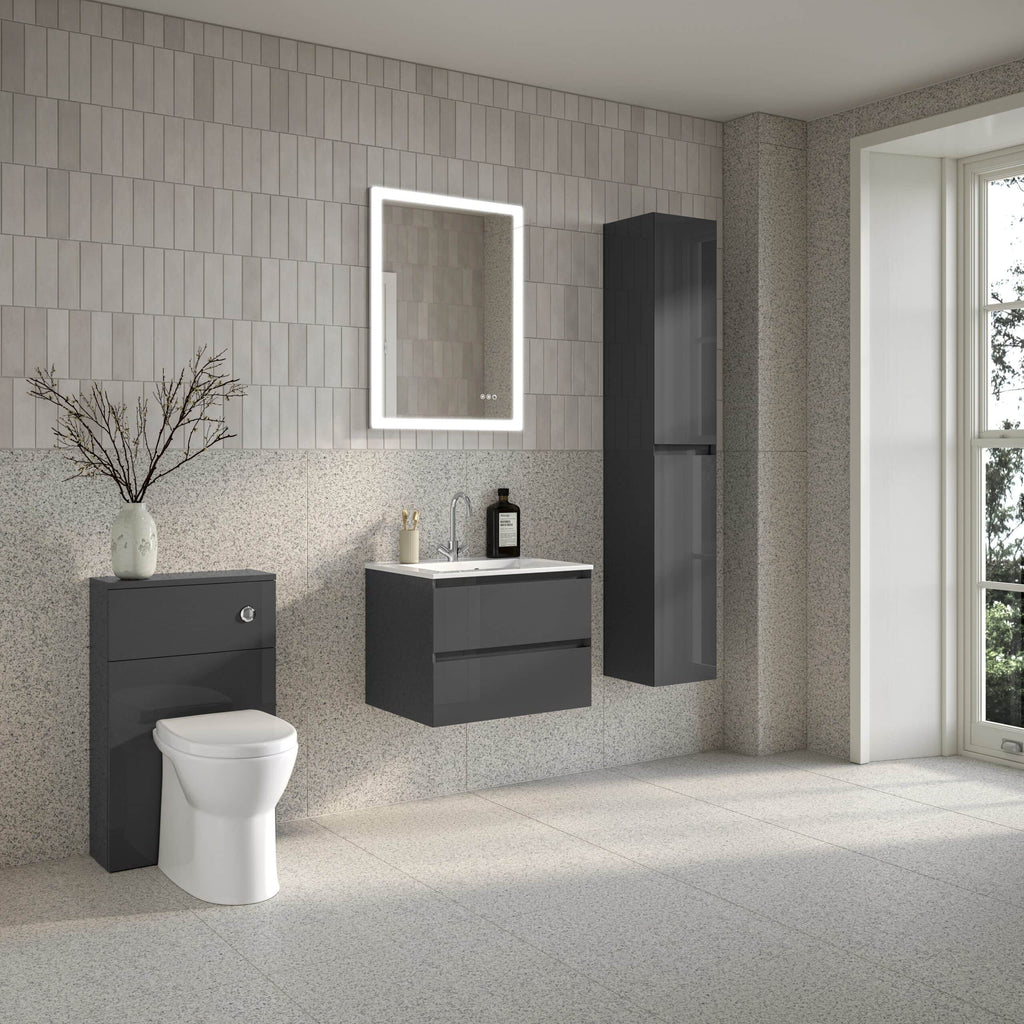 Modern minimalist bathroom with grey wall-mounted vanity, sleek mirror with LED lighting, wall cabinet, toilet, and large window, showcasing contemporary bathroom furniture from Bubly Bathrooms.