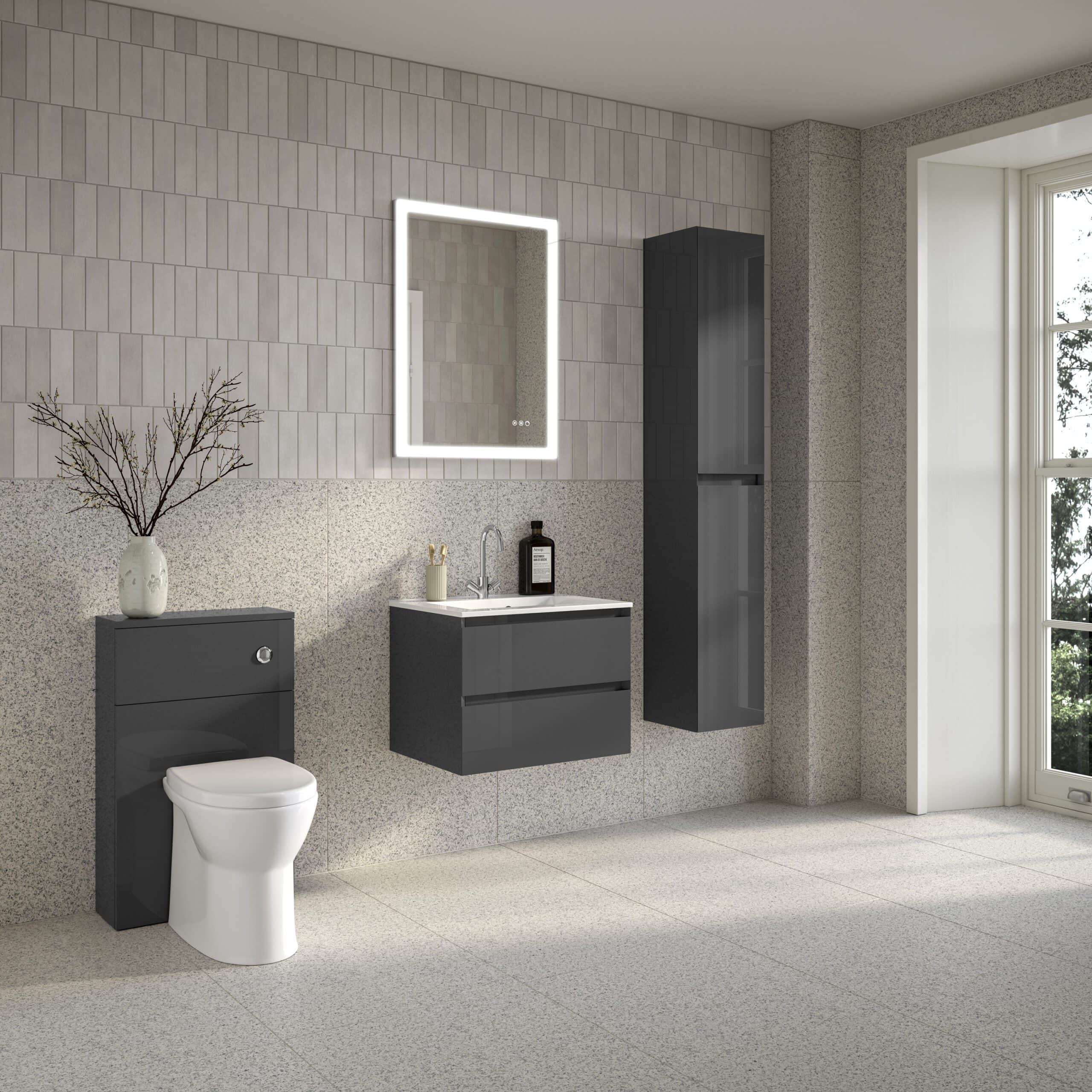 Modern minimalist bathroom with grey wall-mounted vanity, sleek mirror with LED lighting, wall cabinet, toilet, and large window, showcasing contemporary bathroom furniture from Bubly Bathrooms.