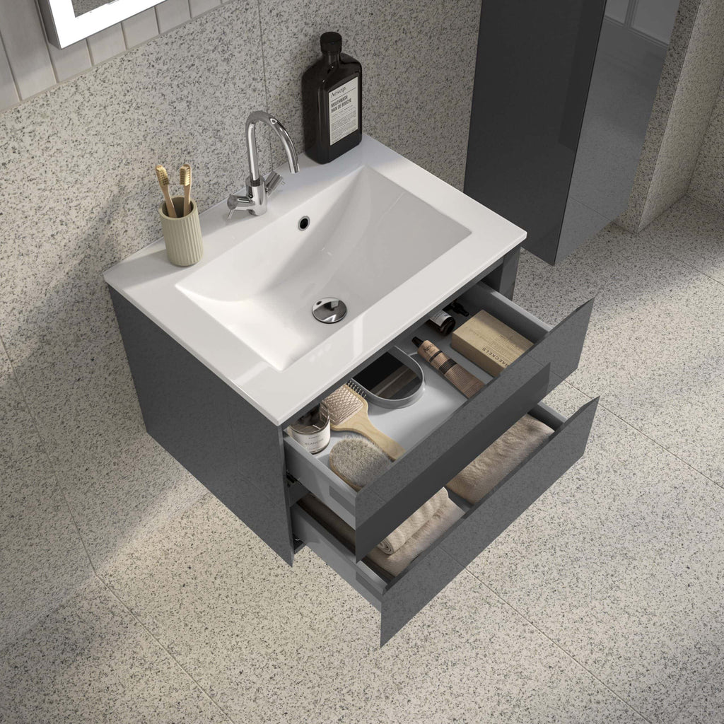 Sleek modern bathroom vanity with grey cabinetry, open drawers filled with neatly organised towels and toiletries, white ceramic sink, chrome tap, and minimalist design for contemporary bathrooms.