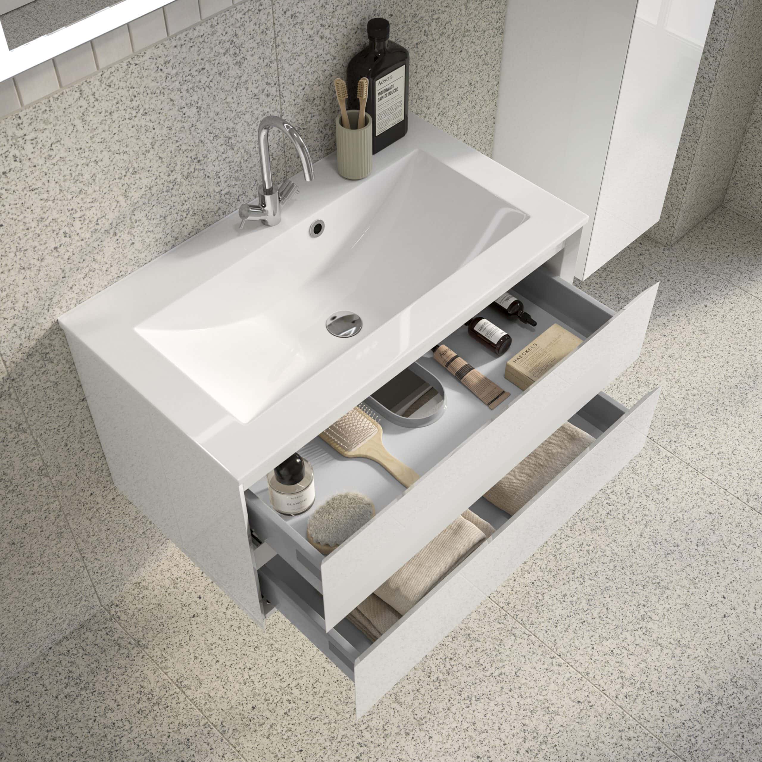 Modern white bathroom vanity with open drawers containing toiletries and accessories, bathroom sink with sleek chrome tap, ideal for contemporary bathroom interiors.