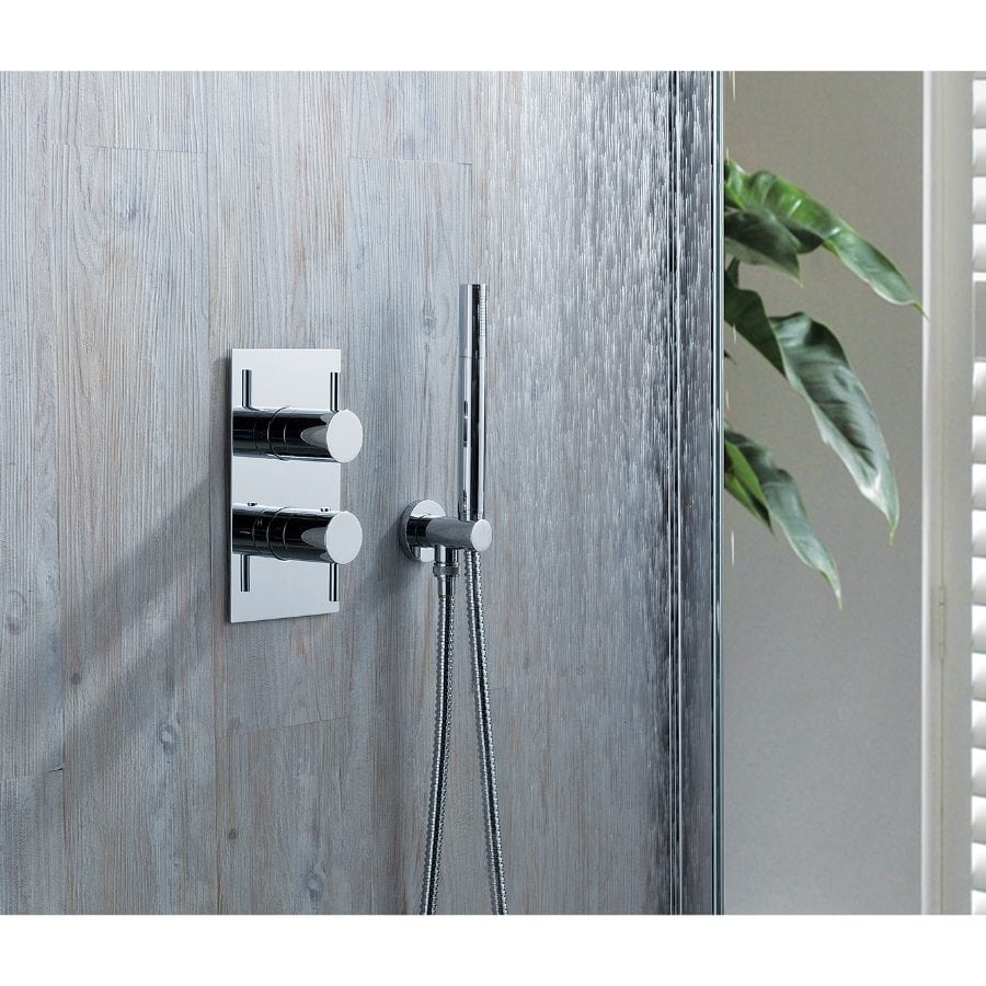 Chrome shower controls with a handheld shower head in a modern bathroom, featuring sleek fixtures and a water-resistant textured wall.