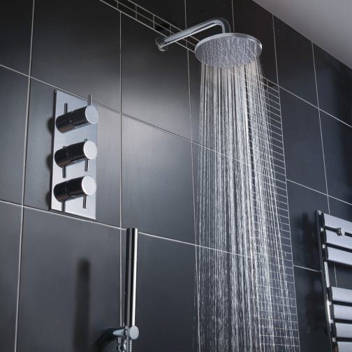 Luxurious black tiled bathroom shower with overhead rain sender and modern thermostatic control panel, perfect for contemporary bathroom designs.