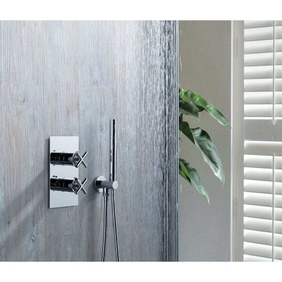 Chrome shower controls with a handheld showerhead on a modern bathroom wall.