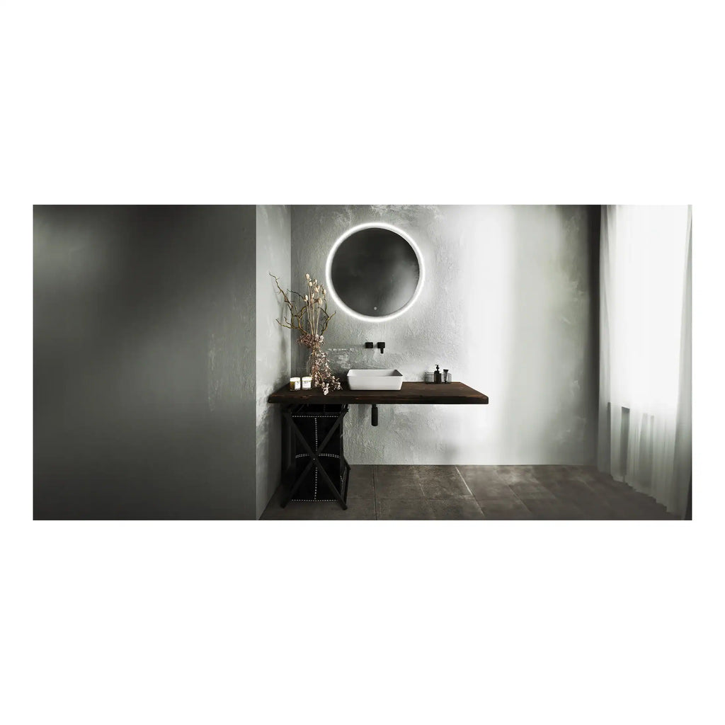 Modern minimalist bathroom featuring a sleek white vessel sink, round illuminated mirror, and elegant dark wood vanity with contemporary accessories.