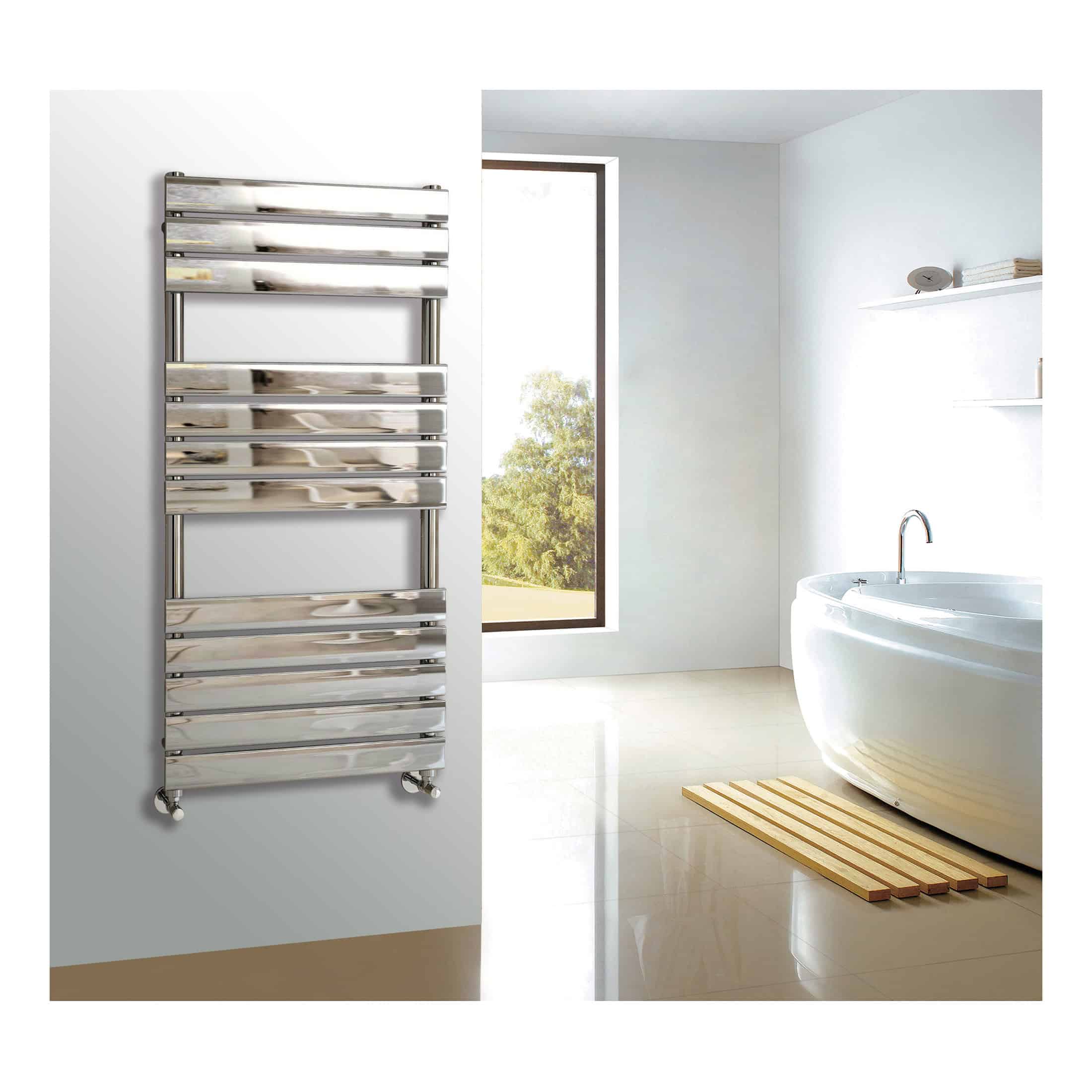 Polished stainless steel heated towel rail in modern bathroom with freestanding bathtub, large window, light-coloured walls, and minimalistic decor. Ideal for luxury bathroom designs.