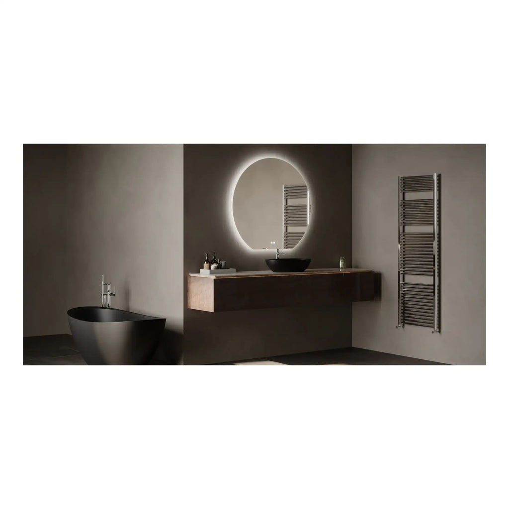 Black freestanding bathtub and modern bathroom vanity with illuminated round mirror, minimalist sink, and heated towel rail in a sleek, contemporary bathroom design.
