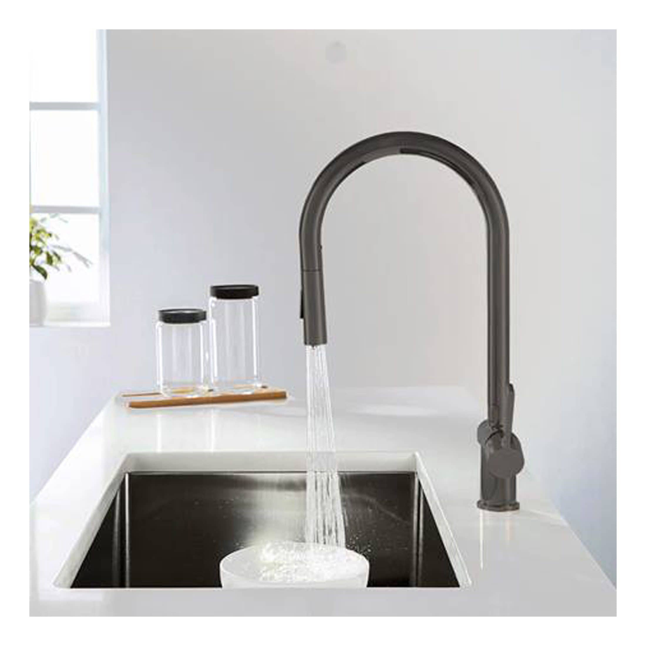Sleek black kitchen tap installed over a stainless steel sink with running water, featuring a modern design perfect for contemporary bathrooms and kitchens.
