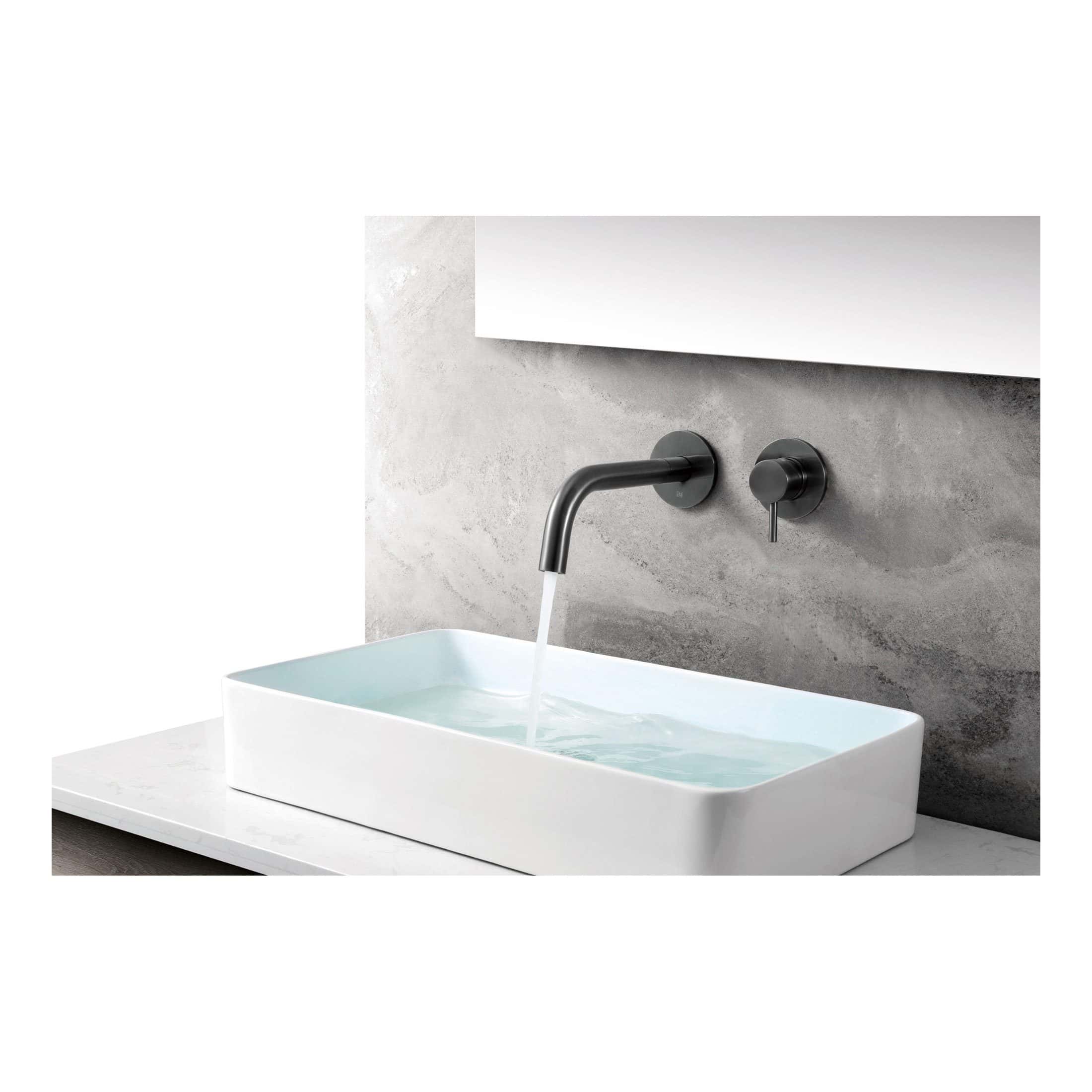Sleek black wall-mounted bathroom tap with a matching lever, pouring water into a modern white rectangular basin against a textured grey wall. Perfect for contemporary bathrooms.