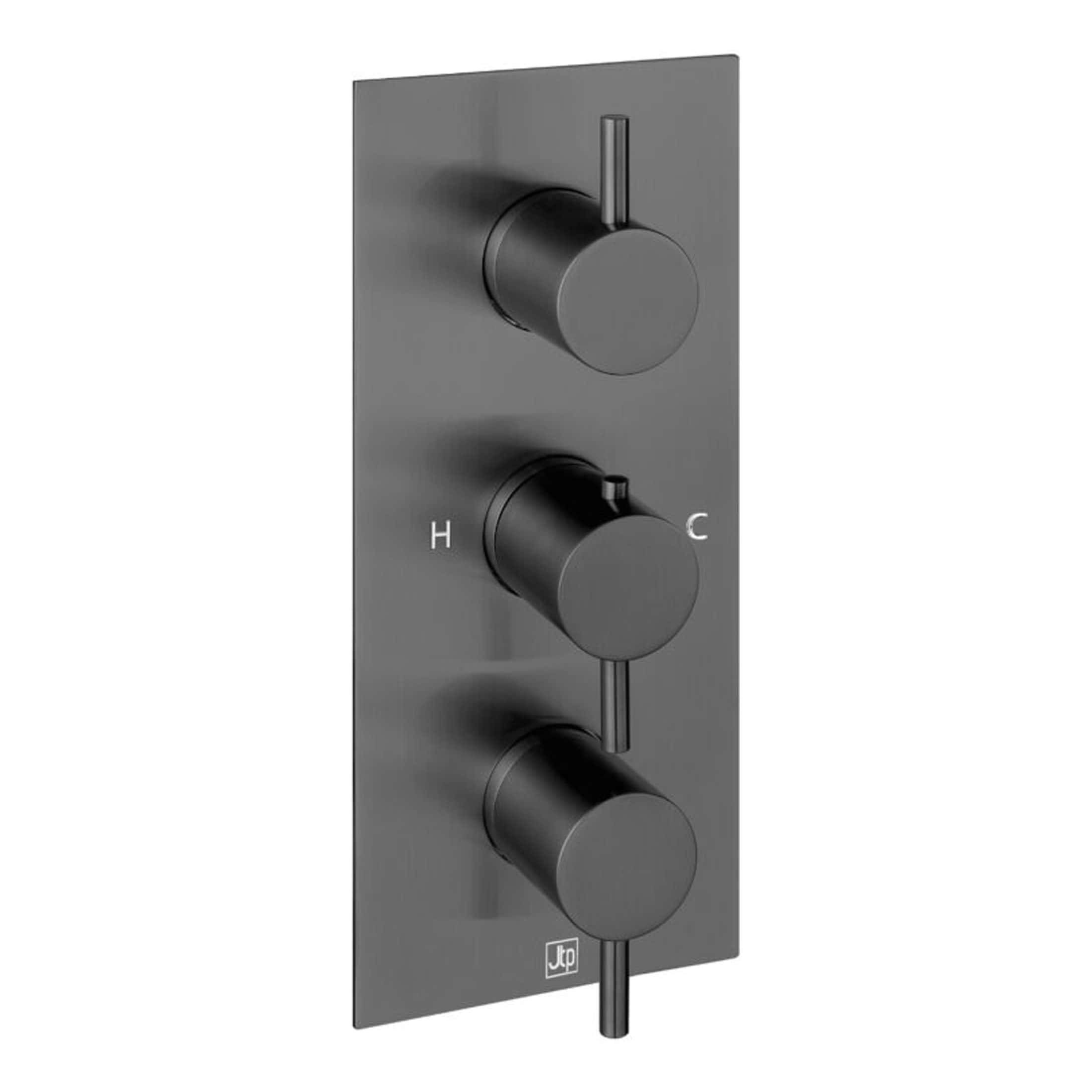 Shower thermostat control panel with three black dials and temperature markings, modern bathroom fixture for precise water temperature regulation.