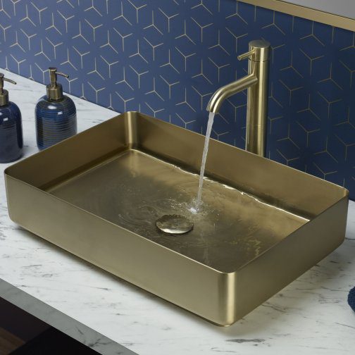 Elegant gold bathroom sink with modern tap and blue patterned tile backdrop, perfect for contemporary bathroom designs. Crafted for style and functionality, ideal for upgrading your bathroom décor.