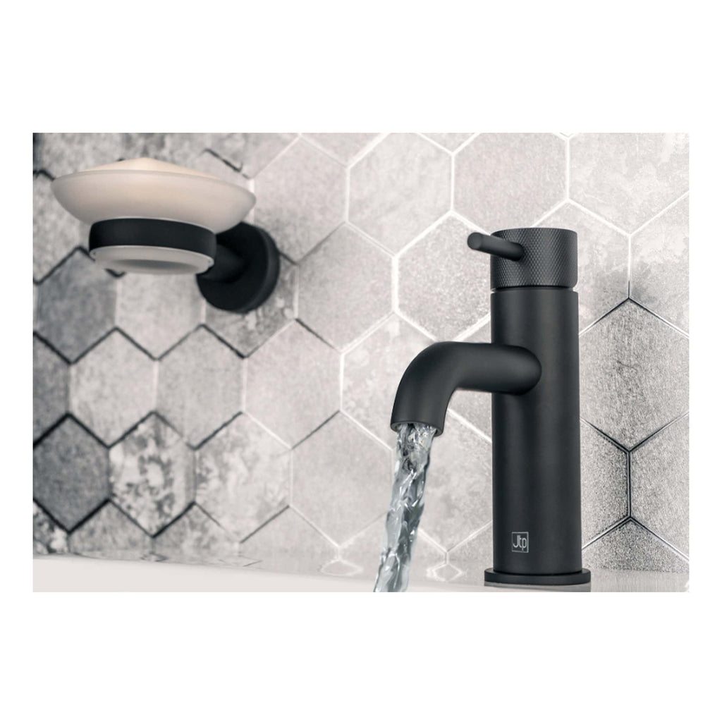 Sleek matte black bathroom tap with water flowing, modern bathroom sink fixture, against a textured grey tile wall, showcasing contemporary bathroom design and premium fixtures.