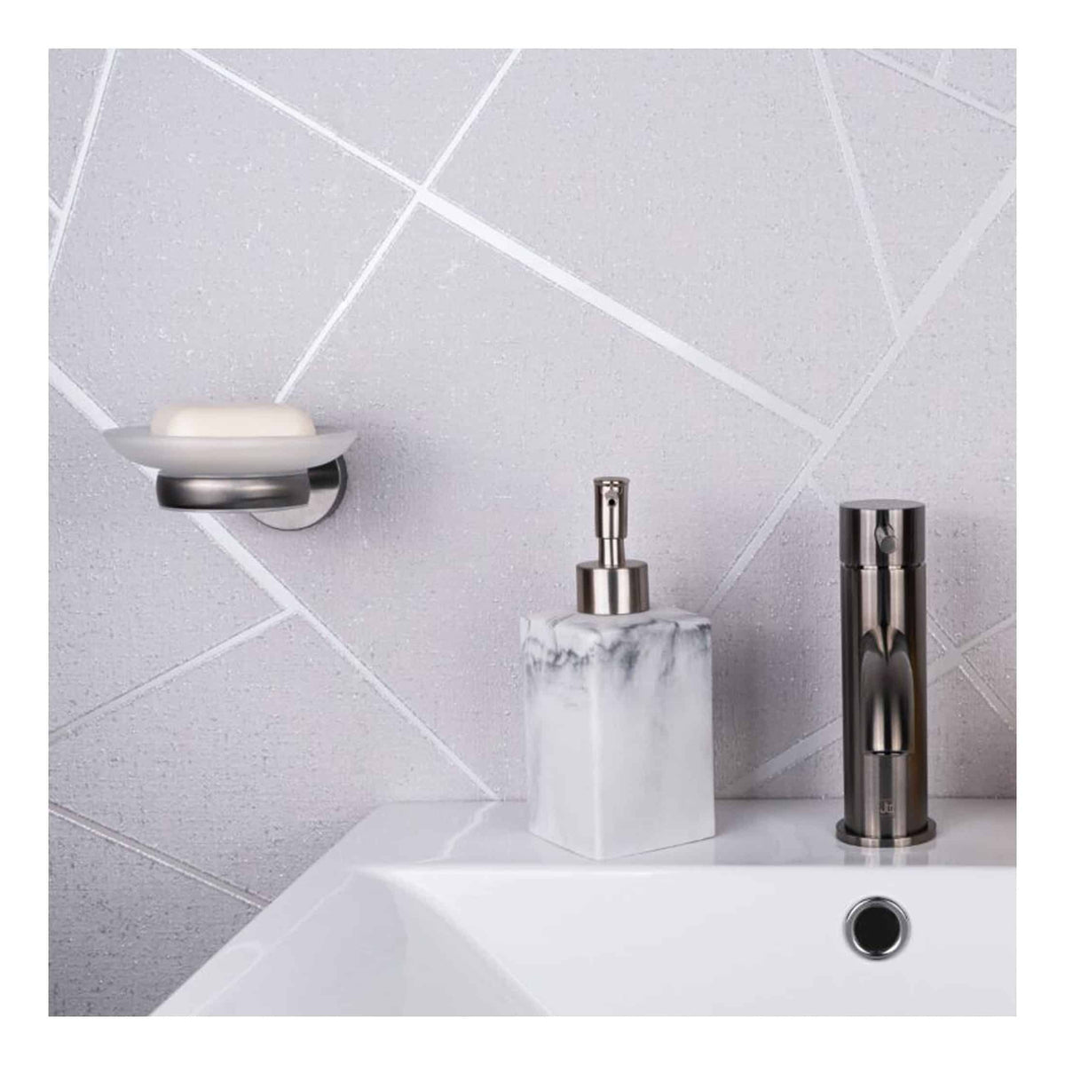 Sleek modern bathroom sink with chrome faucet, marble soap dispenser, and wall-mounted soap dish against textured grey tile wall. Perfect for stylish bathroom renovations.