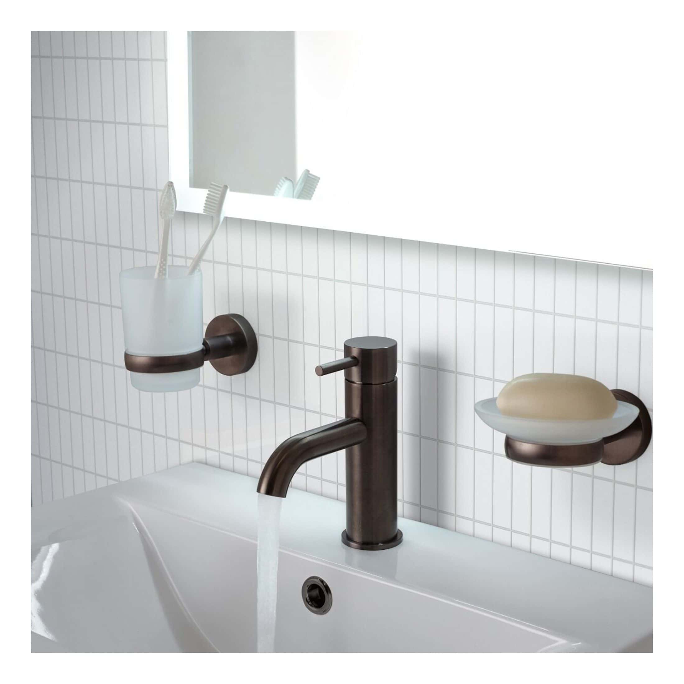 Shower bath accessories set including soap dish and toothbrush holder with a modern matte bronze finish in a contemporary bathroom.