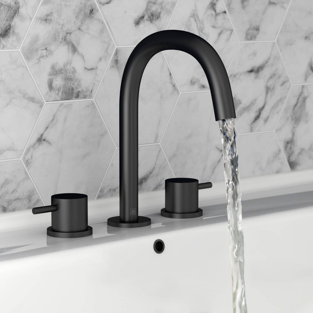 Sleek black bathroom taps with a modern matte finish, fitted on a white bathtub against a stylish white marble hexagon tiled wall. Perfect for contemporary bathroom design and water efficiency.