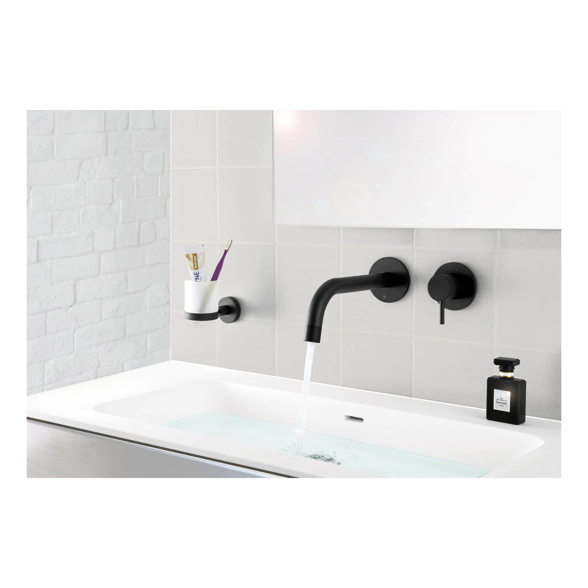 Contemporary black bathroom tap with a sleek design, mounted on white wall tiles, with draining soap dispenser and toothbrush holder, ideal for modern bathroom renovation and plumbing.