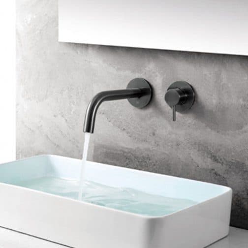 Sleek modern bathroom sink with wall-mounted matte black faucet and grey textured wall background, showcasing contemporary design and water flow for stylish bathroom decor.