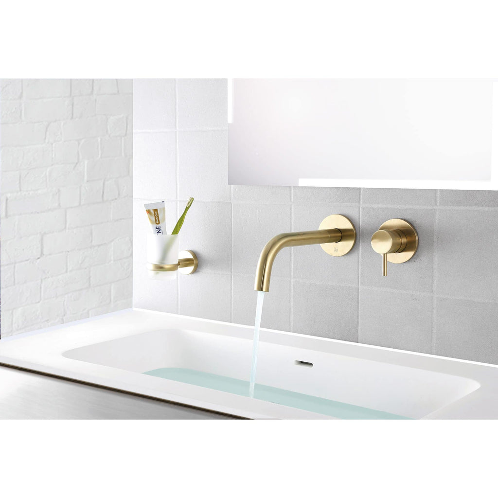 Brass bathroom tap with waterfall spout and matching wall fixtures in a modern minimalist bathroom setting. Features a sleek, contemporary design perfect for stylish bathroom renovations.
