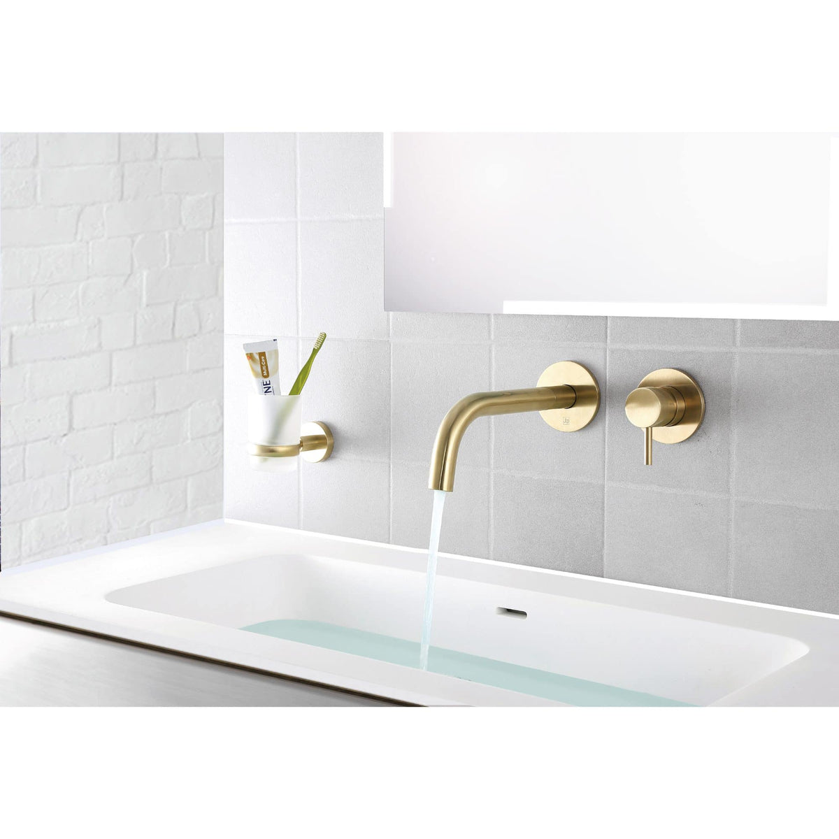 Brass bathroom tap with waterfall spout and matching wall fixtures in a modern minimalist bathroom setting. Features a sleek, contemporary design perfect for stylish bathroom renovations.