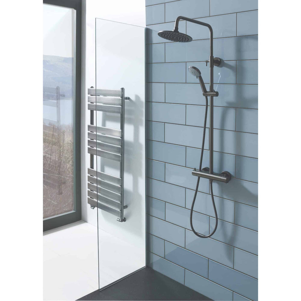 Modern accessible shower system with handheld and overhead shower heads, wall-mounted bracket, and sleek metal fixtures in a contemporary bathroom setting.