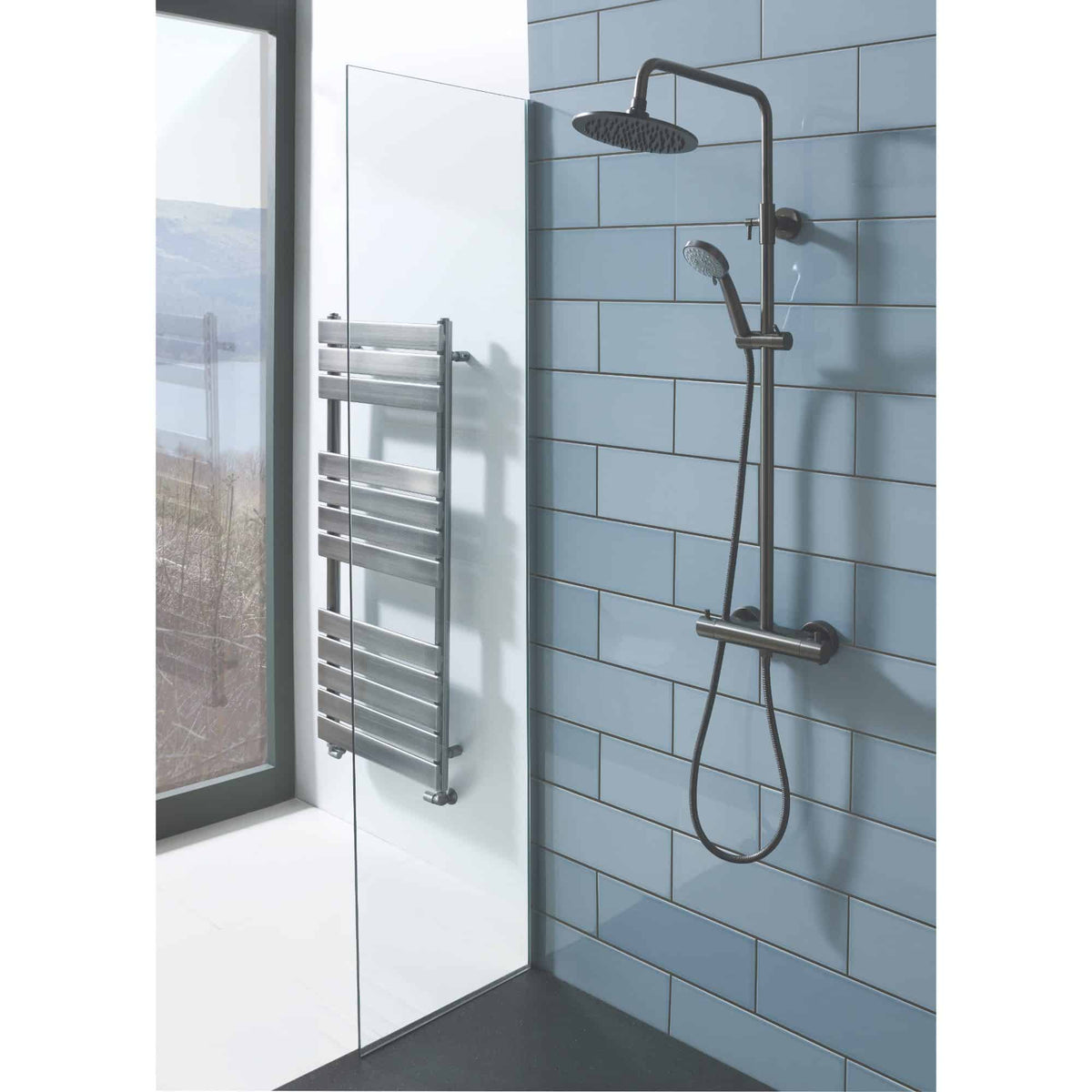 Modern accessible shower system with handheld and overhead shower heads, wall-mounted bracket, and sleek metal fixtures in a contemporary bathroom setting.