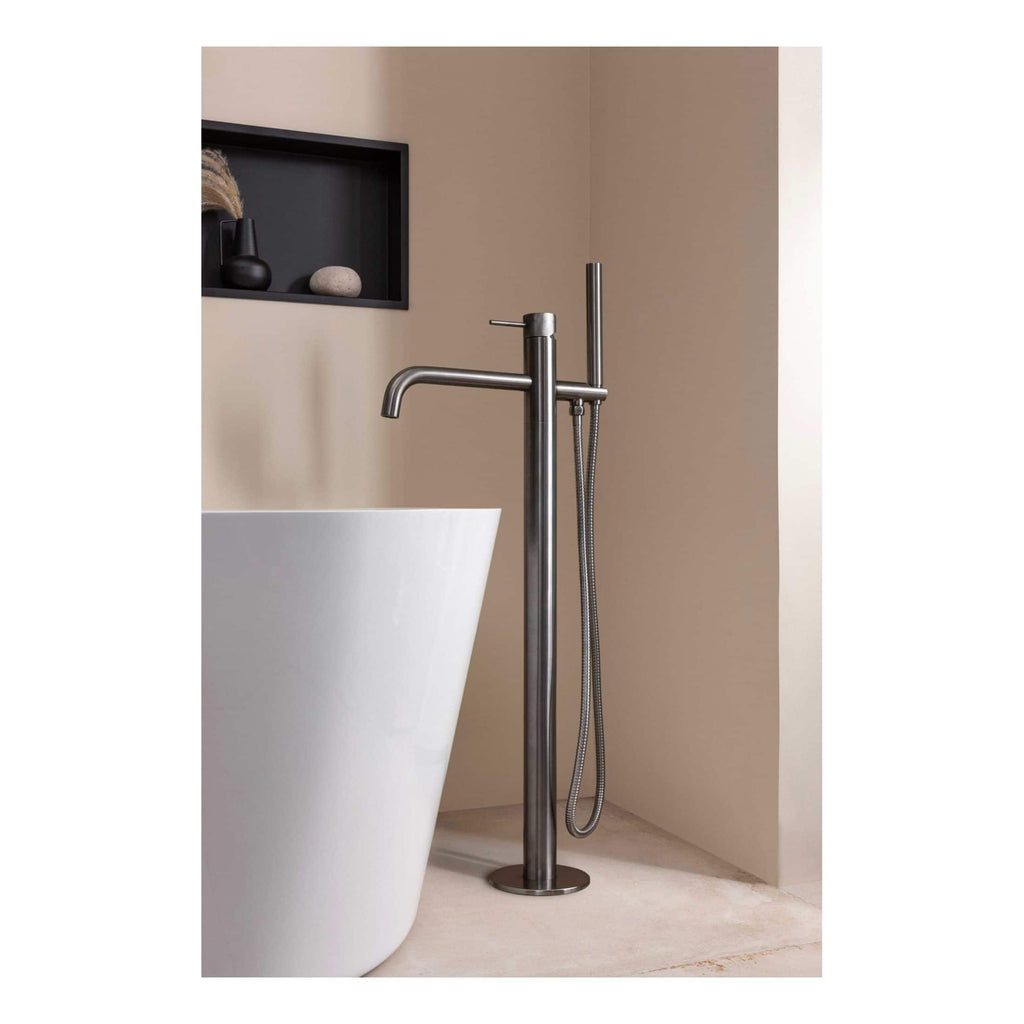 Sleek stainless steel freestanding bathroom faucet with hand shower in modern bathroom setting. Perfect for contemporary bath designs, combining style and functionality.