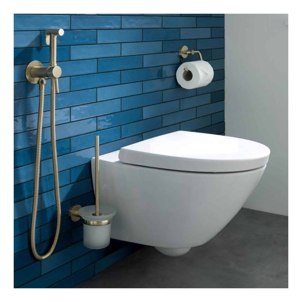 Sleek modern toilet with a wall-mounted flush system, paired with stylish blue tiled walls and brass bathroom accessories, ideal for contemporary bathroom designs.