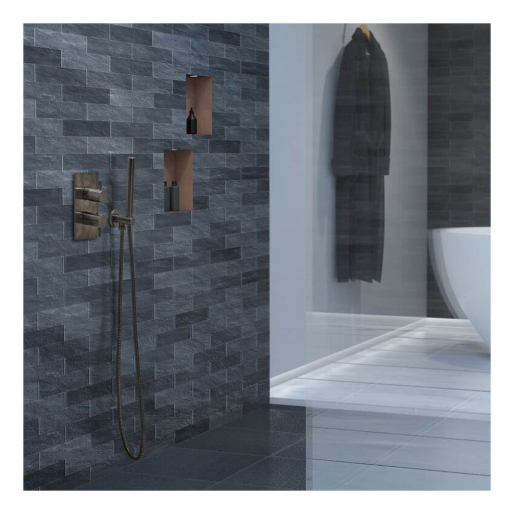 Sleek modern bathroom with grey textured tiles, wall-mounted shower fixtures, built-in shelves, and a contemporary white toilet, showcasing elegant Bubly Bathrooms design.