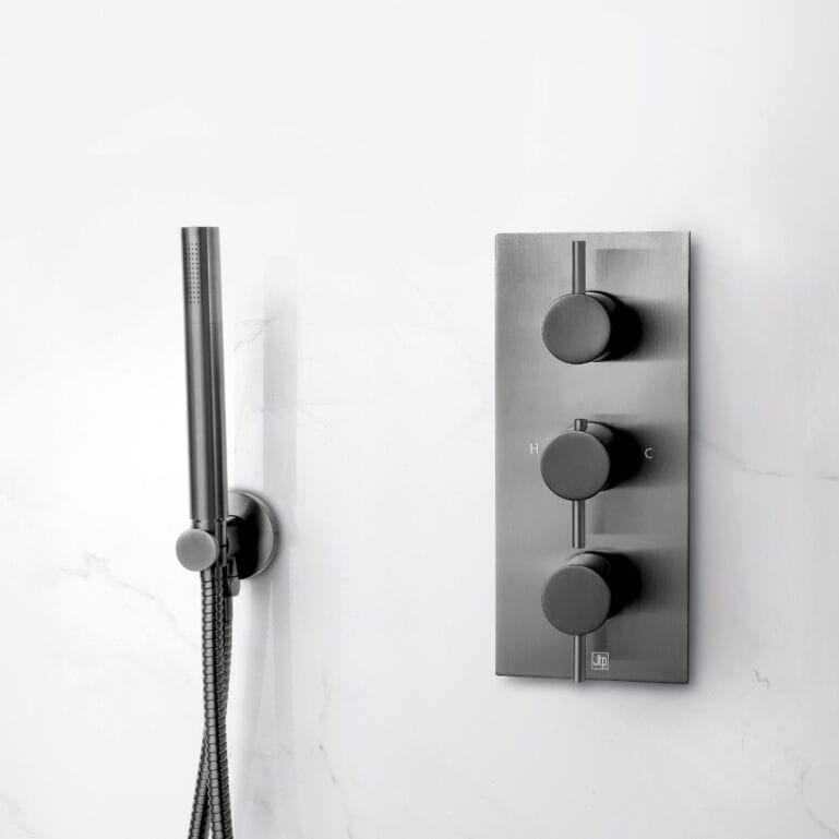 Sleek modern bathroom shower panel with adjustable water controls and handheld shower head in brushed metal finish.
