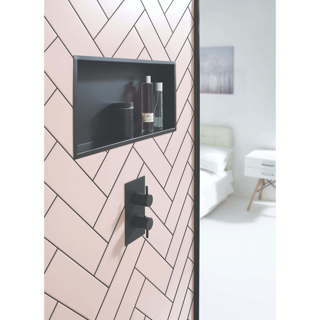 Sleek black shower controls and built-in niche on pink tiled bathroom wall, modern bathroom design, elegant black fixtures, bathroom accessories, contemporary shower upgrade, Bubly Bathrooms UK.