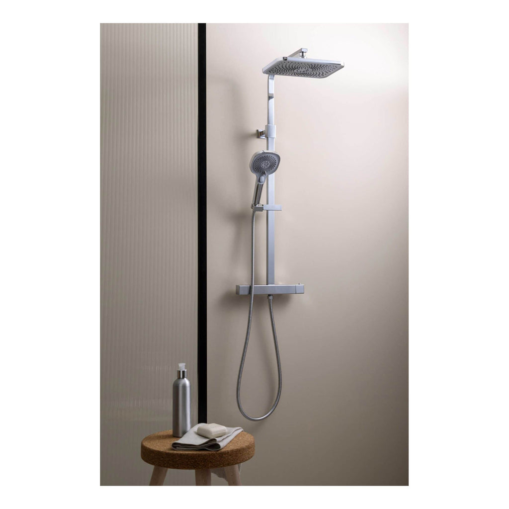 Modern chrome shower system with overhead rain shower, handheld shower head, and adjustable rail for luxurious bathroom makeover.
