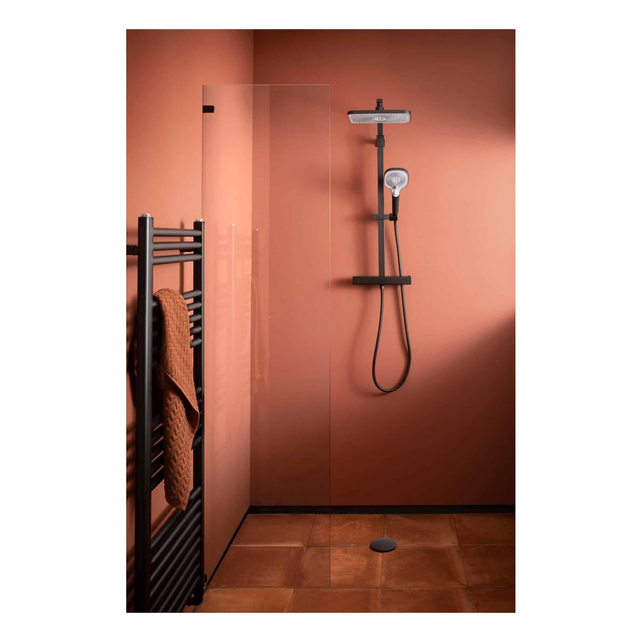 Modular black shower panel with rainfall showerhead and handheld shower on warm terracotta bathroom wall, modern bathroom shower system.