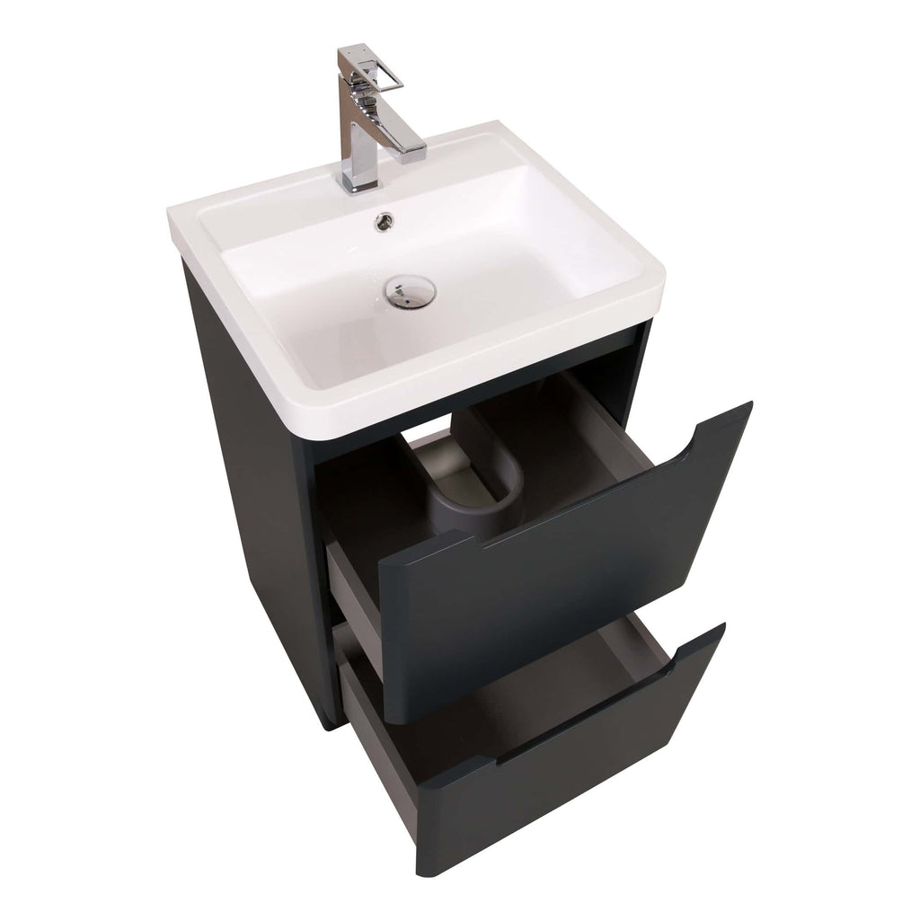 Modern bathroom vanity unit with white ceramic sink, chrome tap, and black storage drawers, perfect for contemporary bathroom designs.