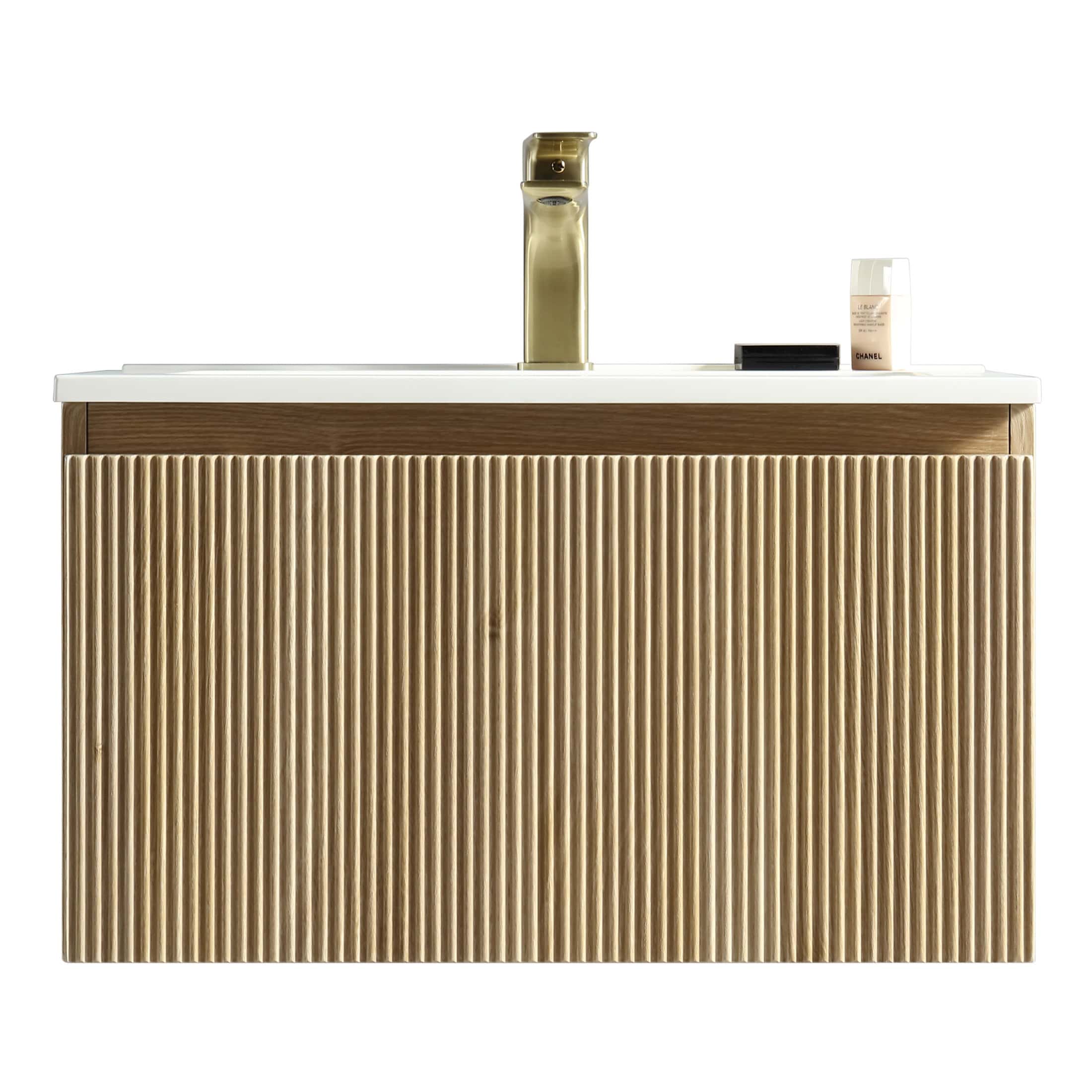 Sleek wooden bathroom vanity with textured front panel, modern gold faucet, and minimalist accessories, designed for stylish and functional bathroom decor improvements.