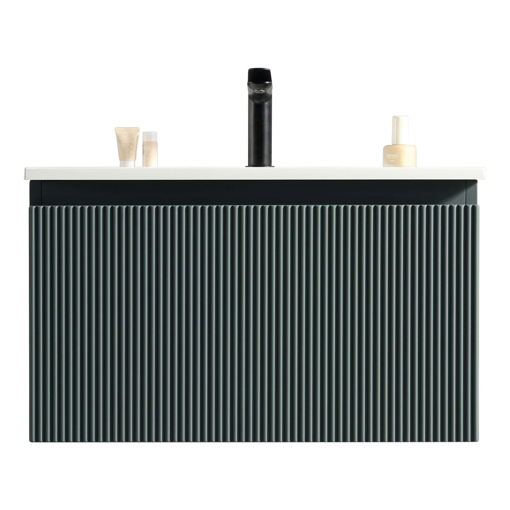 Sleek black and white modern bathroom vanity with vertical ribbed design, minimalist black faucet, and neatly arranged toiletries, perfect for contemporary bathroom interiors.