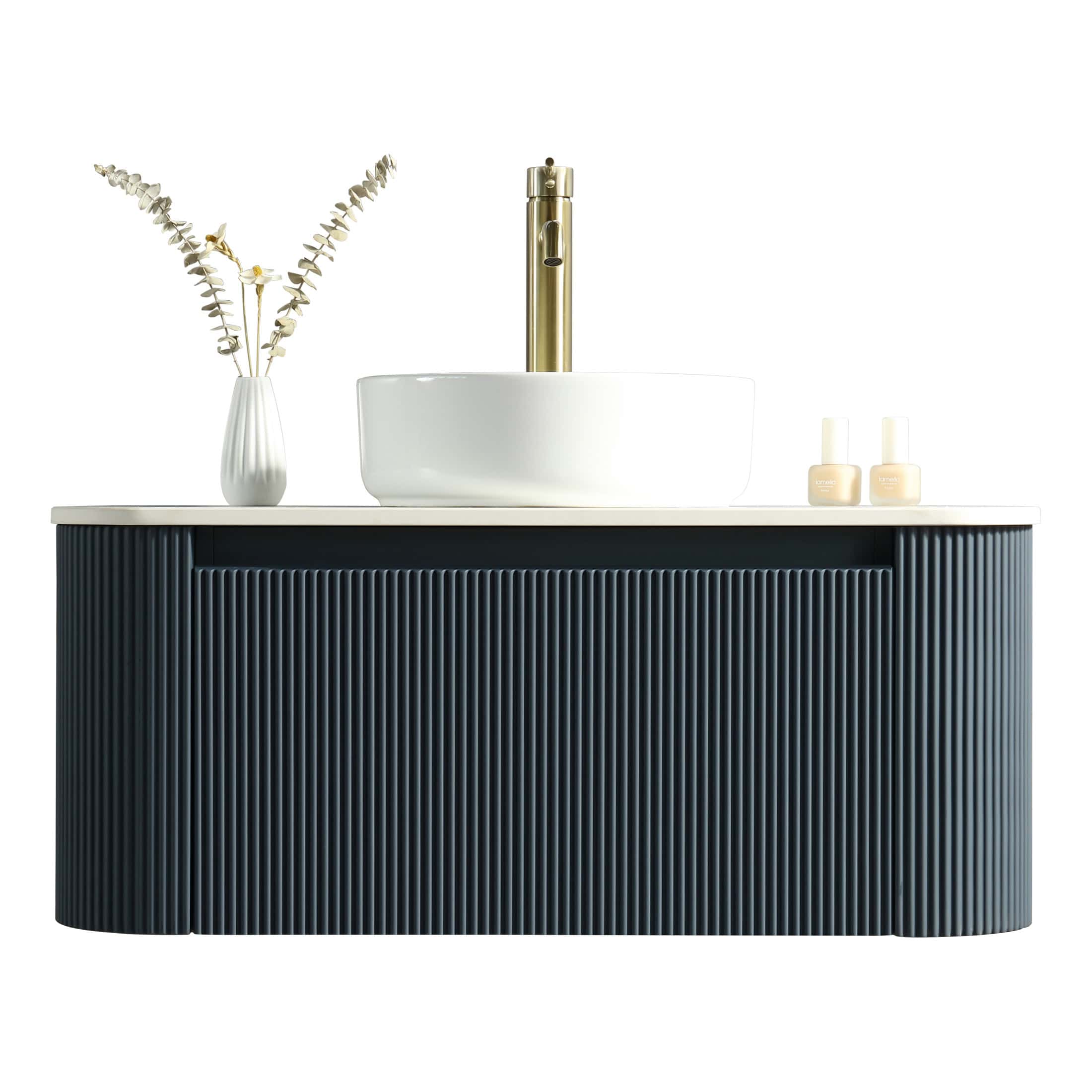 Sleek modern bathroom vanity with a white countertop, black textured cabinet, white vessel sink, gold tap, and minimalist accessories, perfect for contemporary bathroom design.