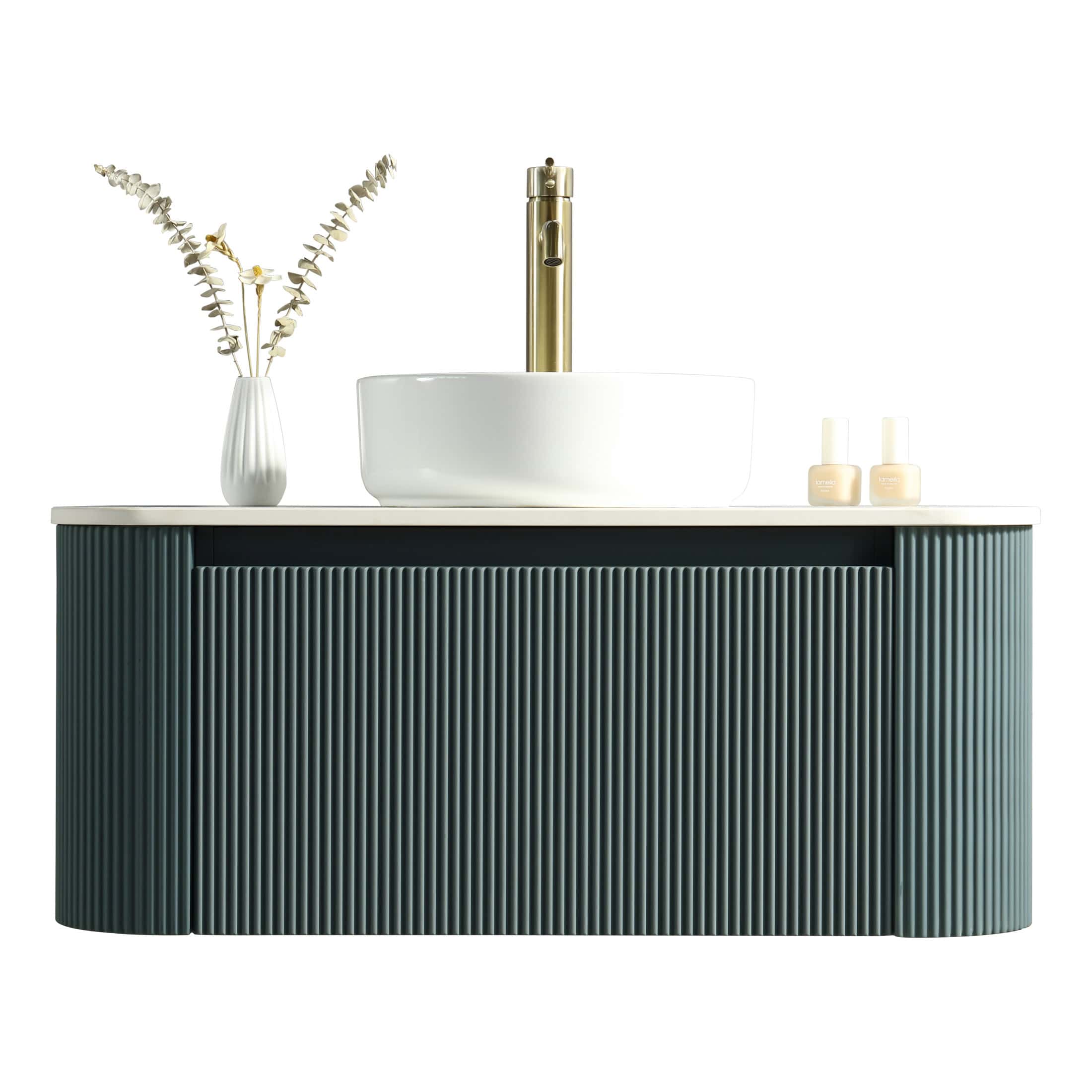 Luxurious freestanding bathroom vanity with a textured dark green cabinet, white countertop, and modern vessel sink featuring a sleek gold faucet. Elegant decor with minimal accessories complements contemporary bathroom design.
