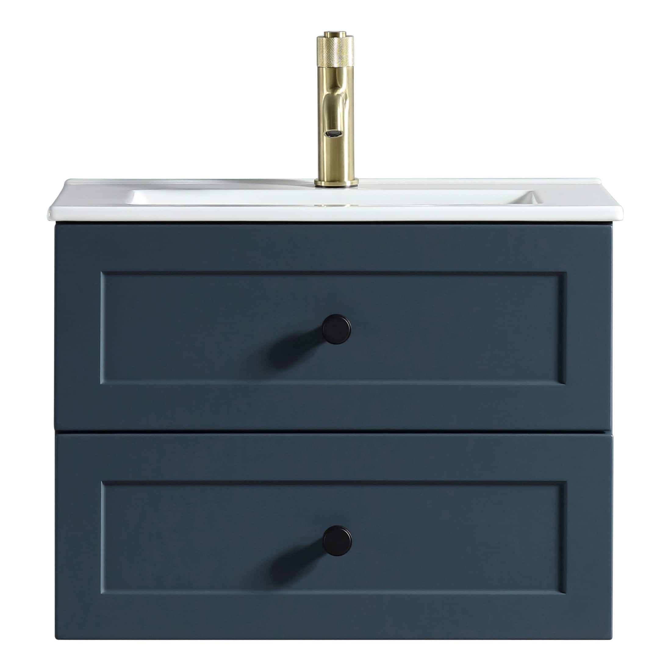 Modern navy blue bathroom vanity with white ceramic sink and brass faucet, featuring two drawers for storage, ideal for contemporary bathroom design.
