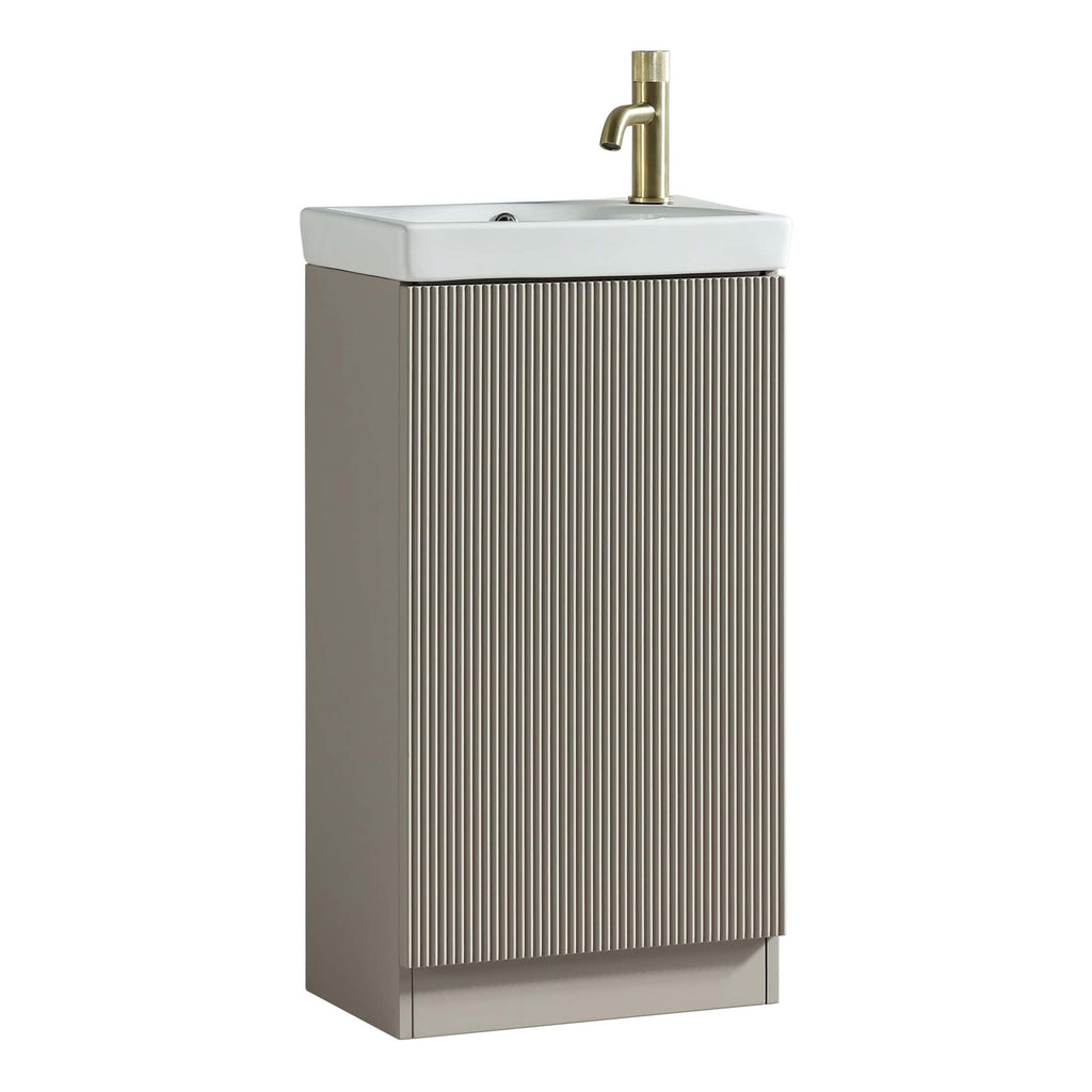 Modern bathroom sink with brass tap and ribbed grey vanity cabinet, ideal for contemporary bathroom designs.