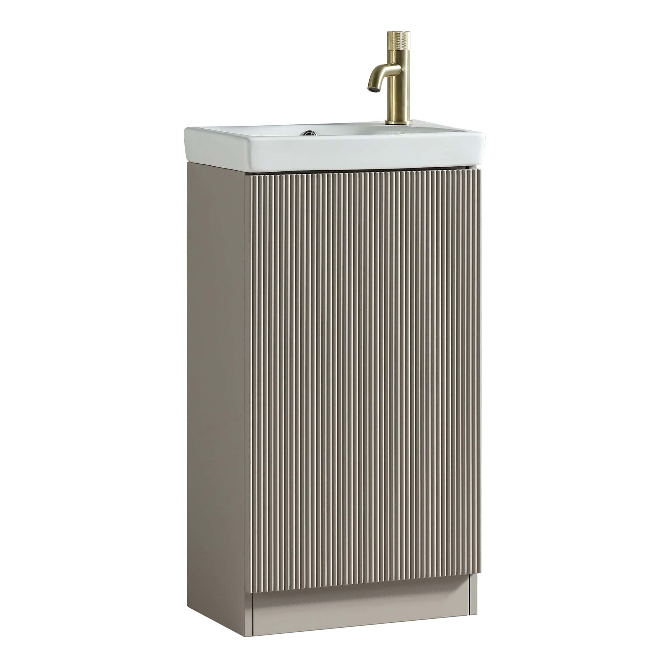 Modern bathroom sink with brass tap and ribbed grey vanity cabinet, ideal for contemporary bathroom designs.
