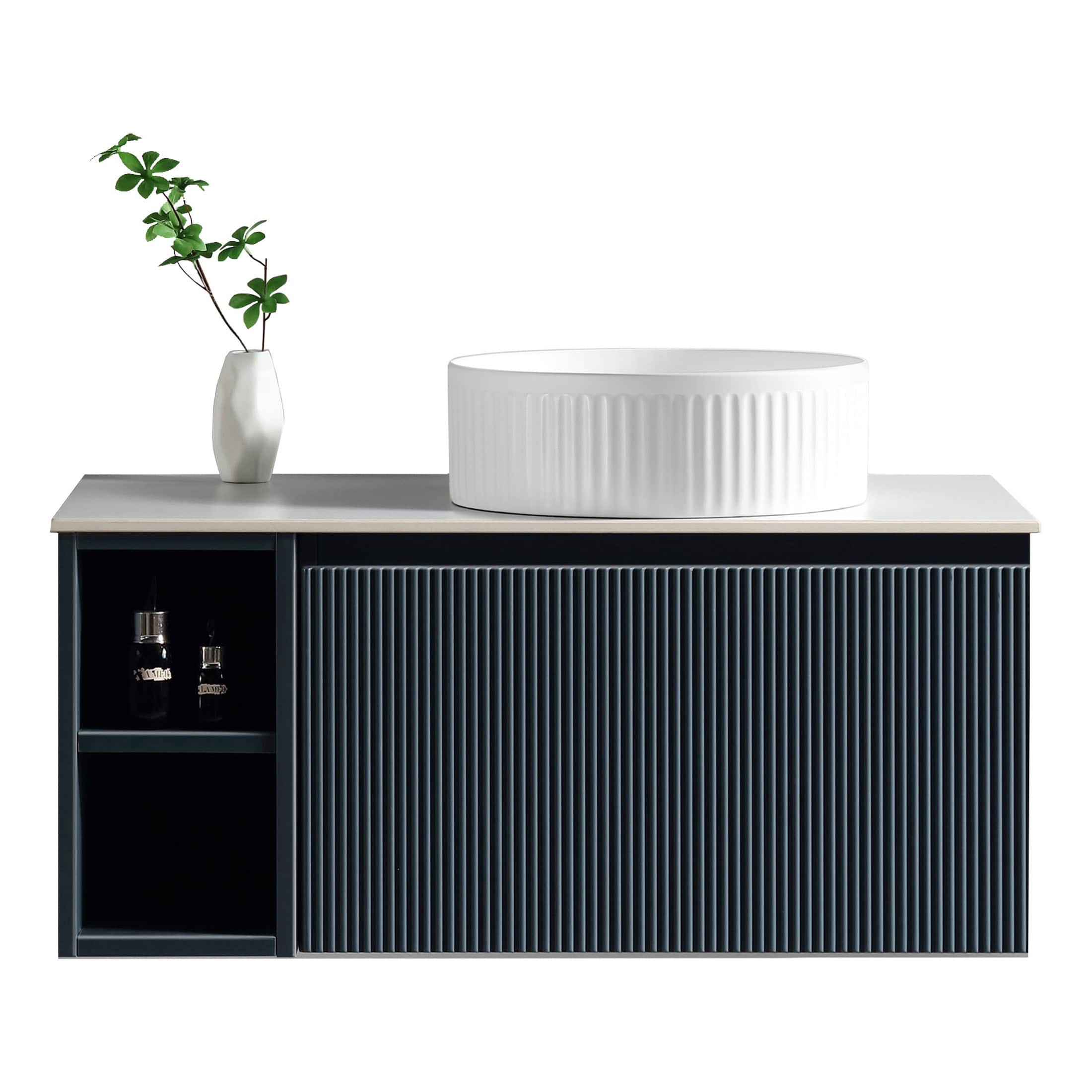 Sleek modern bathroom vanity with a dark blue ribbed cabinet, white countertop, and stylish vessel sink, complemented by a white vase with greenery for a contemporary bathroom design.