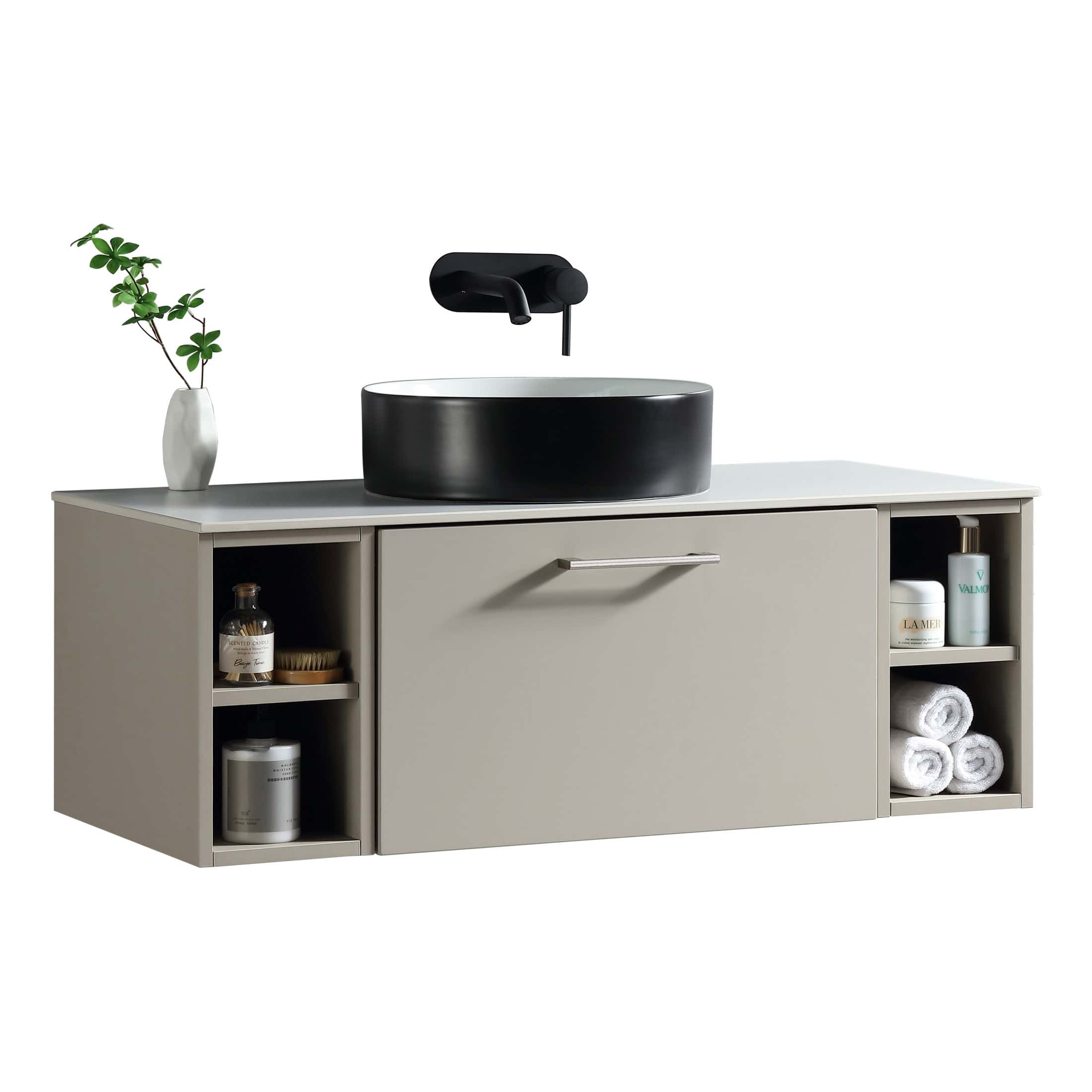 Contemporary beige bathroom vanity with open shelving, a black vessel sink, and a wall-mounted black faucet, complemented by a decorative vase with greenery for modern bathroom design.