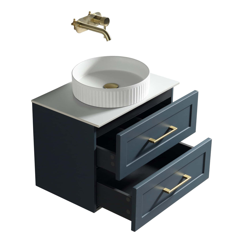 Polished brass bathroom tap mounted above a stylish navy vanity unit with open drawers and a white ceramic vessel sink, ideal for modern bathroom designs.