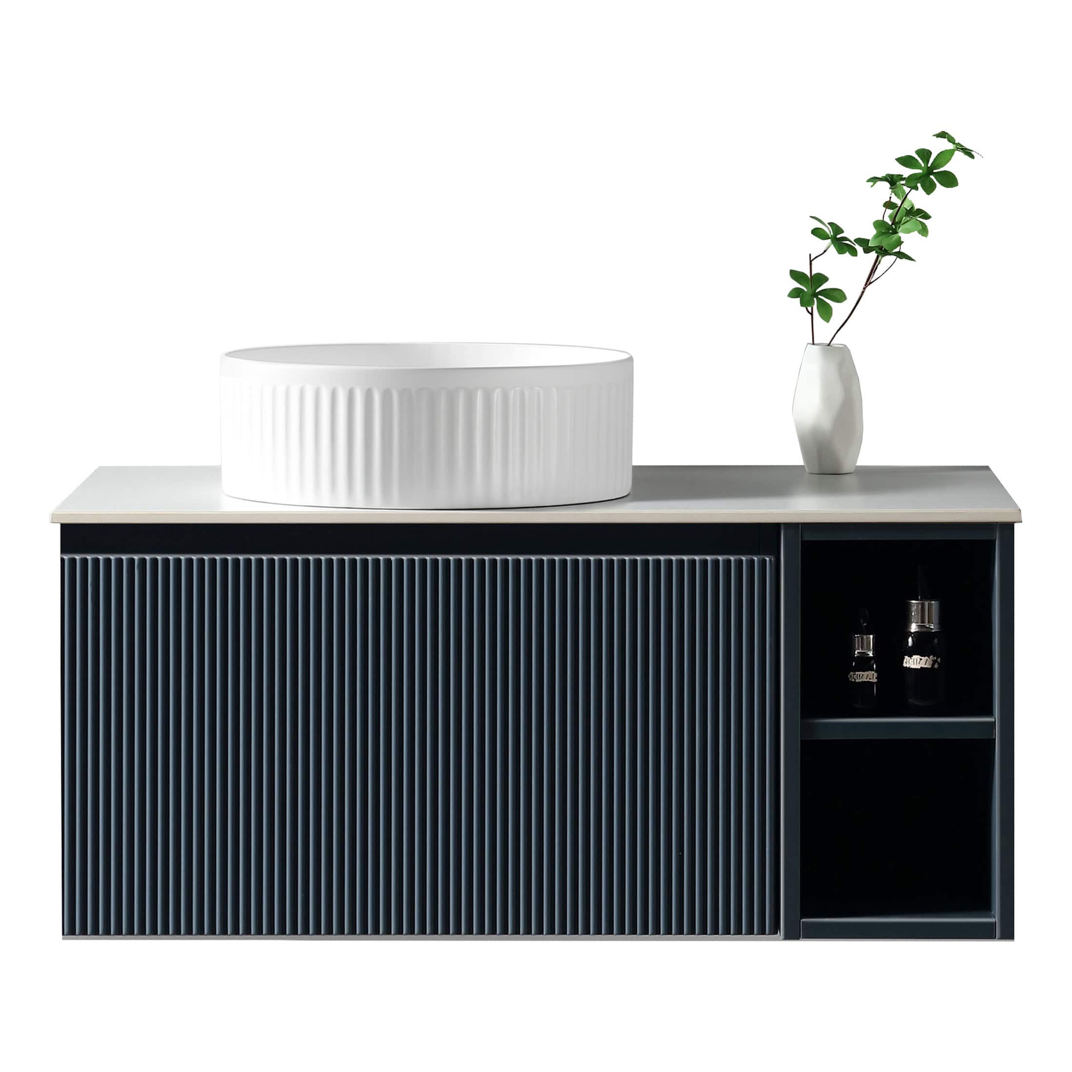 Sleek modern bathroom vanity with a minimalist design, featuring a textured black cabinet and a white vessel sink with vertical ridges, complemented by a white vase with greenery.