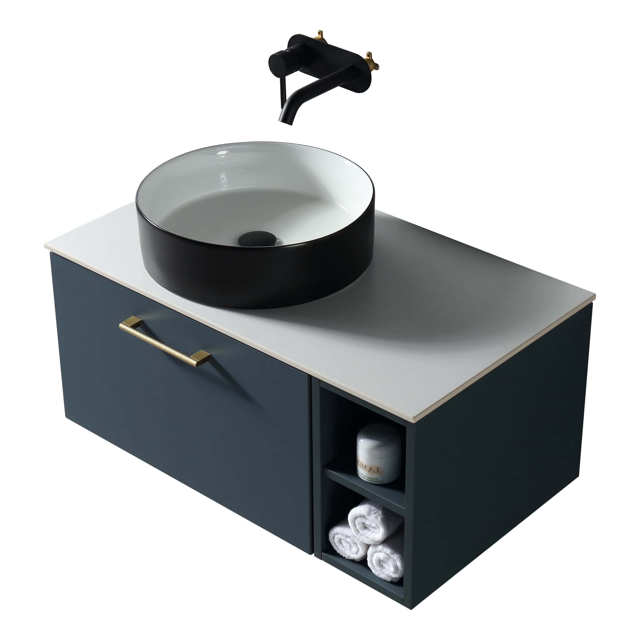 Vessel bathroom sink with black and white colour scheme, modern wall-mounted tap, and bathroom storage unit with towels and toiletries for stylish bathroom decor.