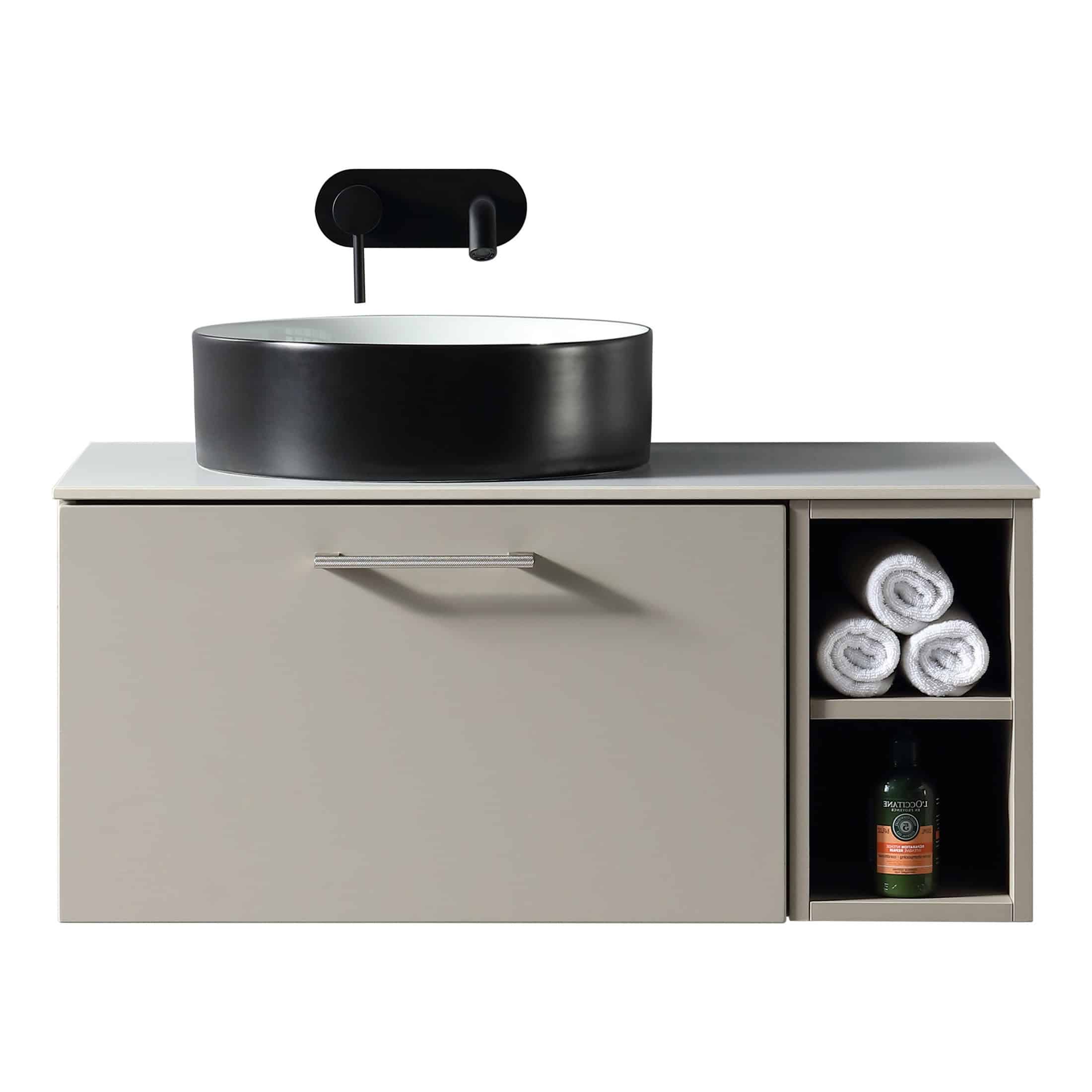 Black and white modern bathroom vanity with vessel sink, wall-mounted faucet, and neatly rolled towels in open storage cubby. Stylish, minimalist bathroom furniture for contemporary bathroom design.
